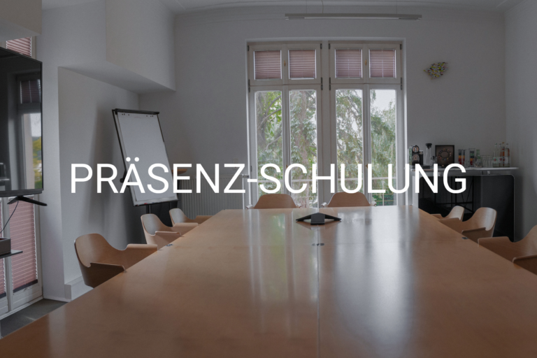 Meeting room set up for a training session with a long wooden table and chairs, whiteboard, and a coffee/bar area; large windows with blinds; text overlay reads 'PRÄSENZ-SCHULUNG'.