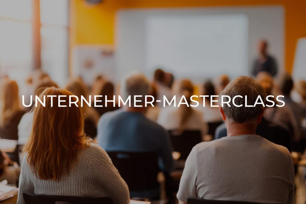 Audience seated facing a presenter in a bright conference room; large overlay text reads 'UNTERNEHMER-MASTERCLASS'