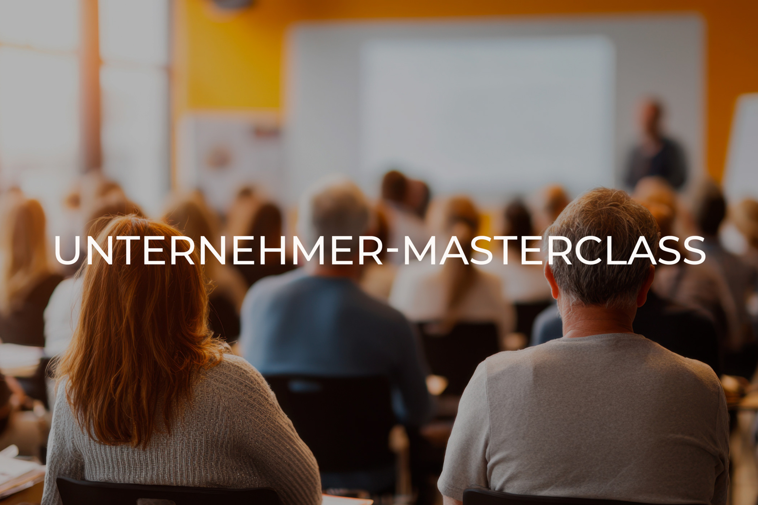 Audience seated facing a presenter in a bright conference room; large overlay text reads 'UNTERNEHMER-MASTERCLASS'